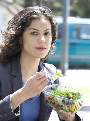 Mujer comiendo ensalada.